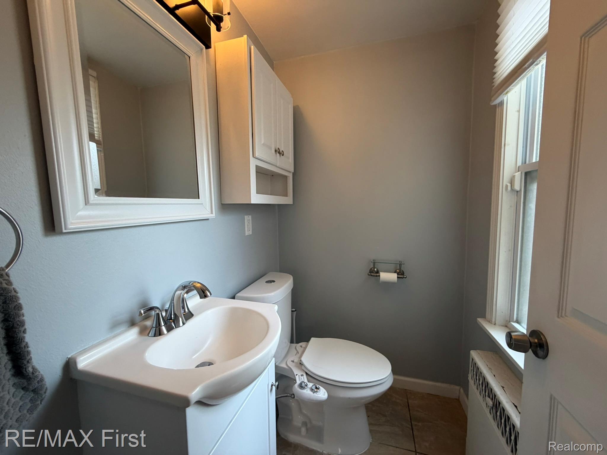 1349 Devonshire Road Grosse Pointe, MI 48230 - Photo 14 of 31 Integrated vanity with basin sink, chrome faucet, and white cabinetry