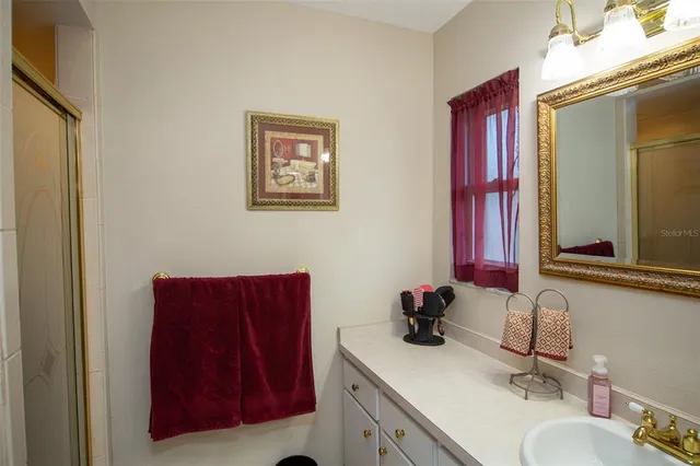 a bathroom with a sink vanity and mirror