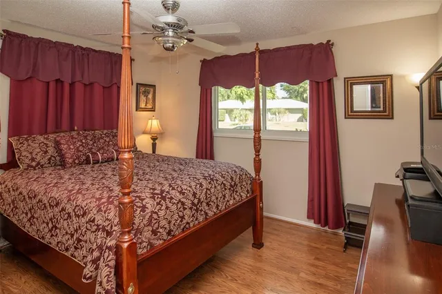 a bed sitting in a bedroom next to a window