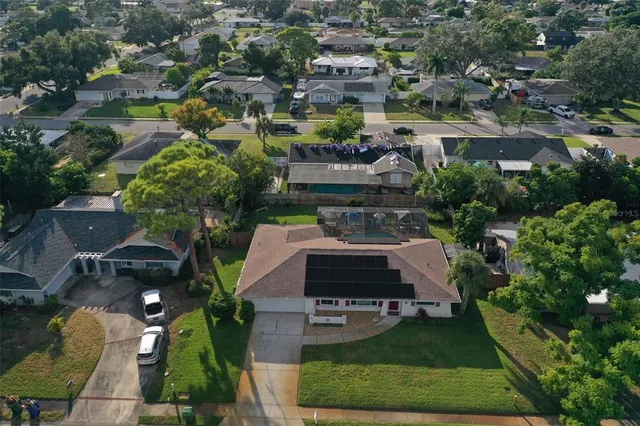 an aerial view of multiple houses with yard