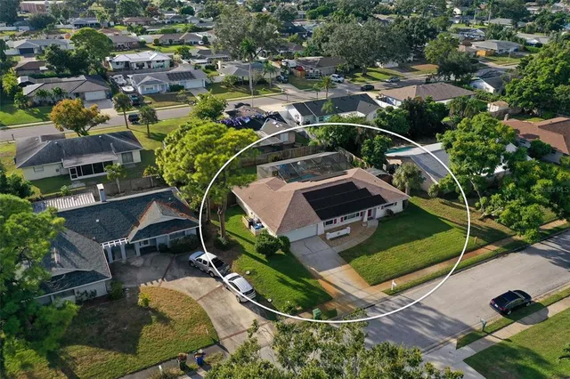 an aerial view of a house with a backyard