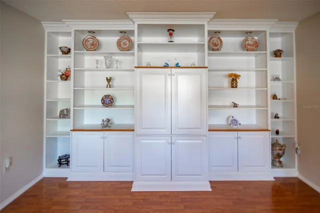 a view of kitchen cabinets with wooden floor
