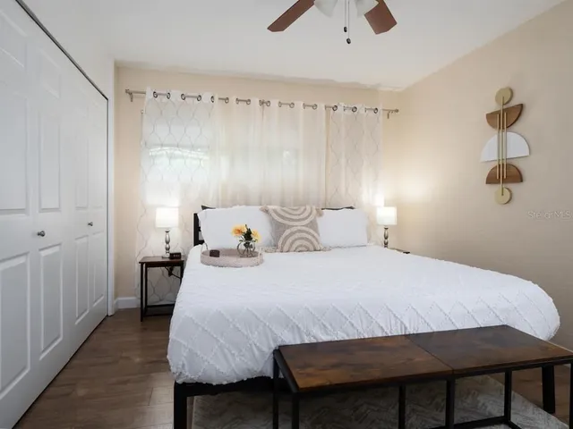 a bedroom with a bed and wooden floor