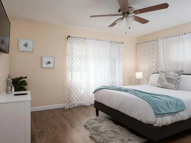 a bedroom with a bed and a window