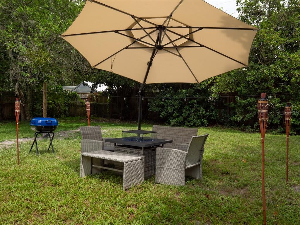1425 Northeast 13th Street Gainesville, FL 32601 - Photo 19 of 20 a backyard of a house with table and chairs