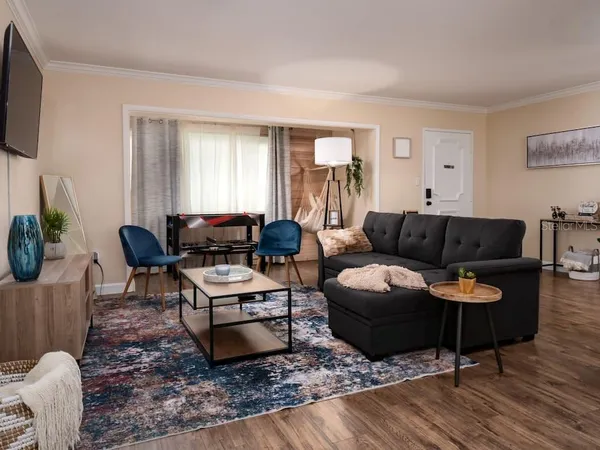 a living room with furniture window and a flat screen tv