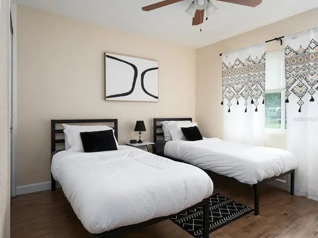 a bedroom with two beds and a table