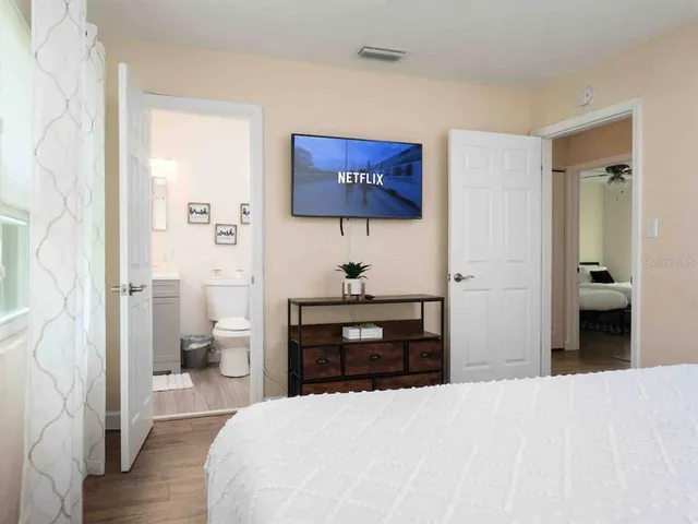 a bedroom with a bed and a view of bathroom