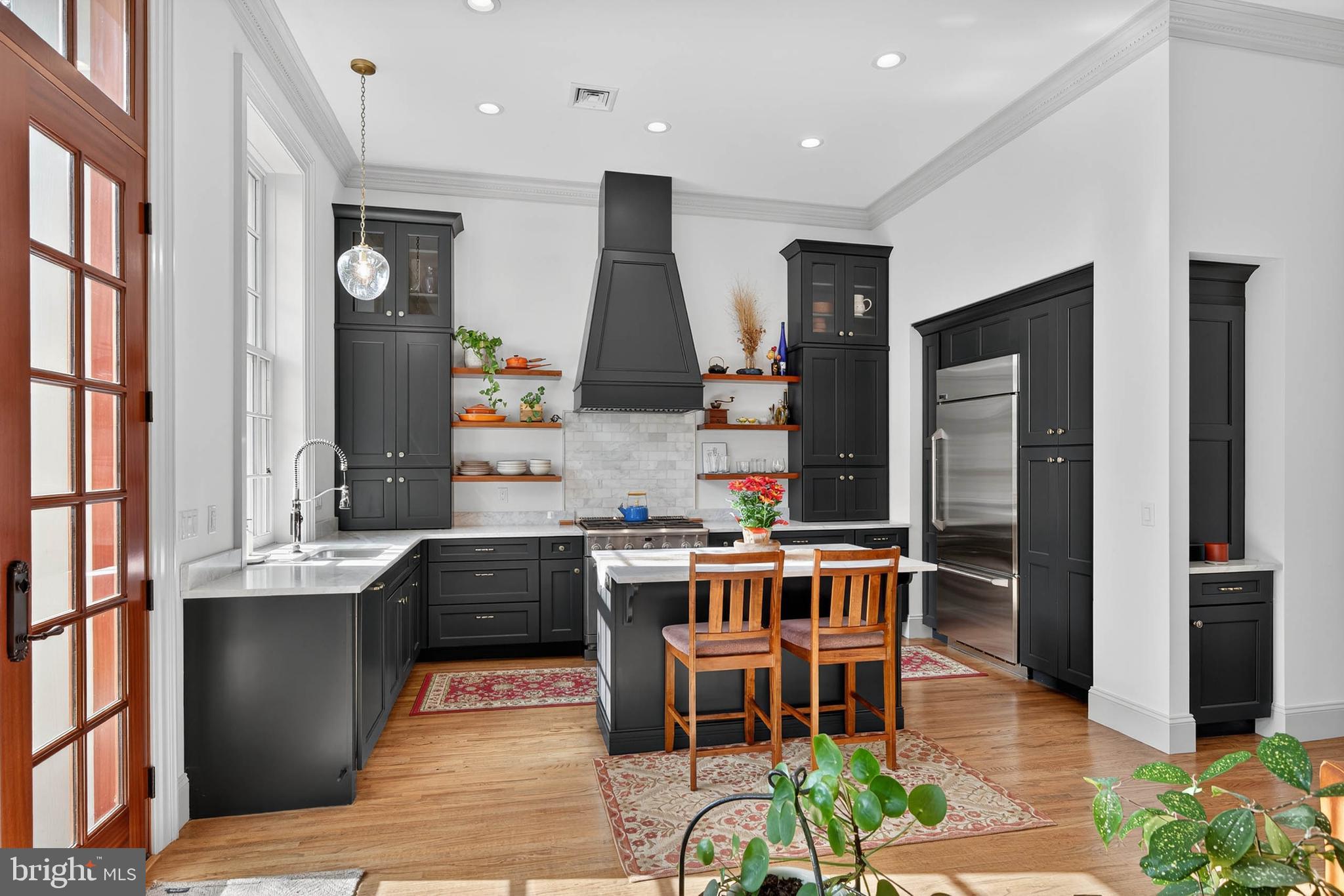 14 East Farnum Street Lancaster, PA 17602 - Photo 15 of 50 a kitchen with stainless steel appliances granite countertop a stove top oven a sink a dining table and chairs