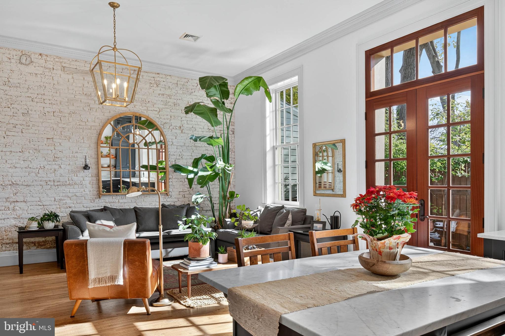 14 East Farnum Street Lancaster, PA 17602 - Photo 27 of 50 a living room with couches chandelier and a dining table with garden view