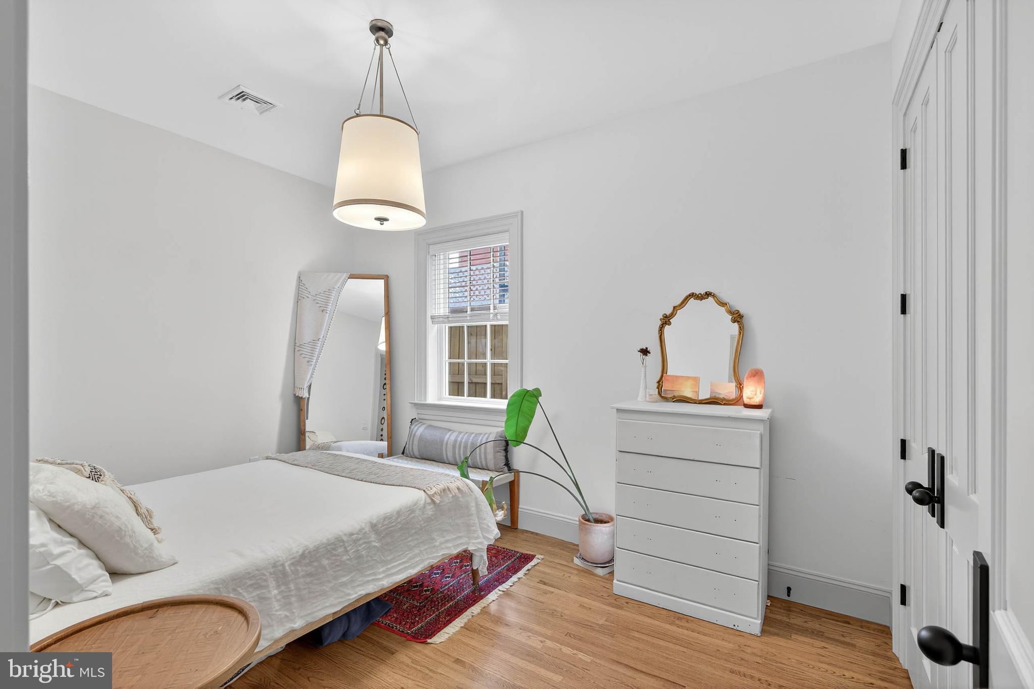 14 East Farnum Street Lancaster, PA 17602 - Photo 31 of 50 a bedroom with a bed and wooden floor