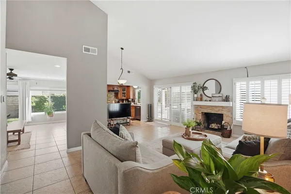 a living room with furniture a flat screen tv and a window