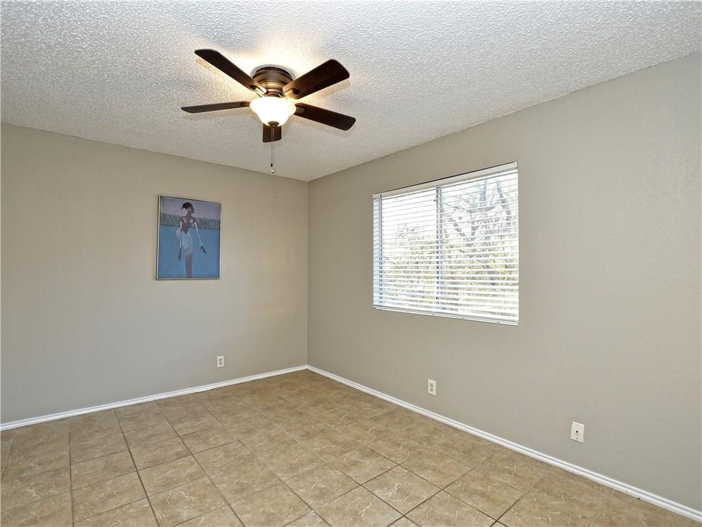 5401 Spring Meadow Road, Unit B Austin, TX 78744 - Photo 10 of 21 Tiled flooring and a ceiling fan create a practical and comfortable environment for everyday living.