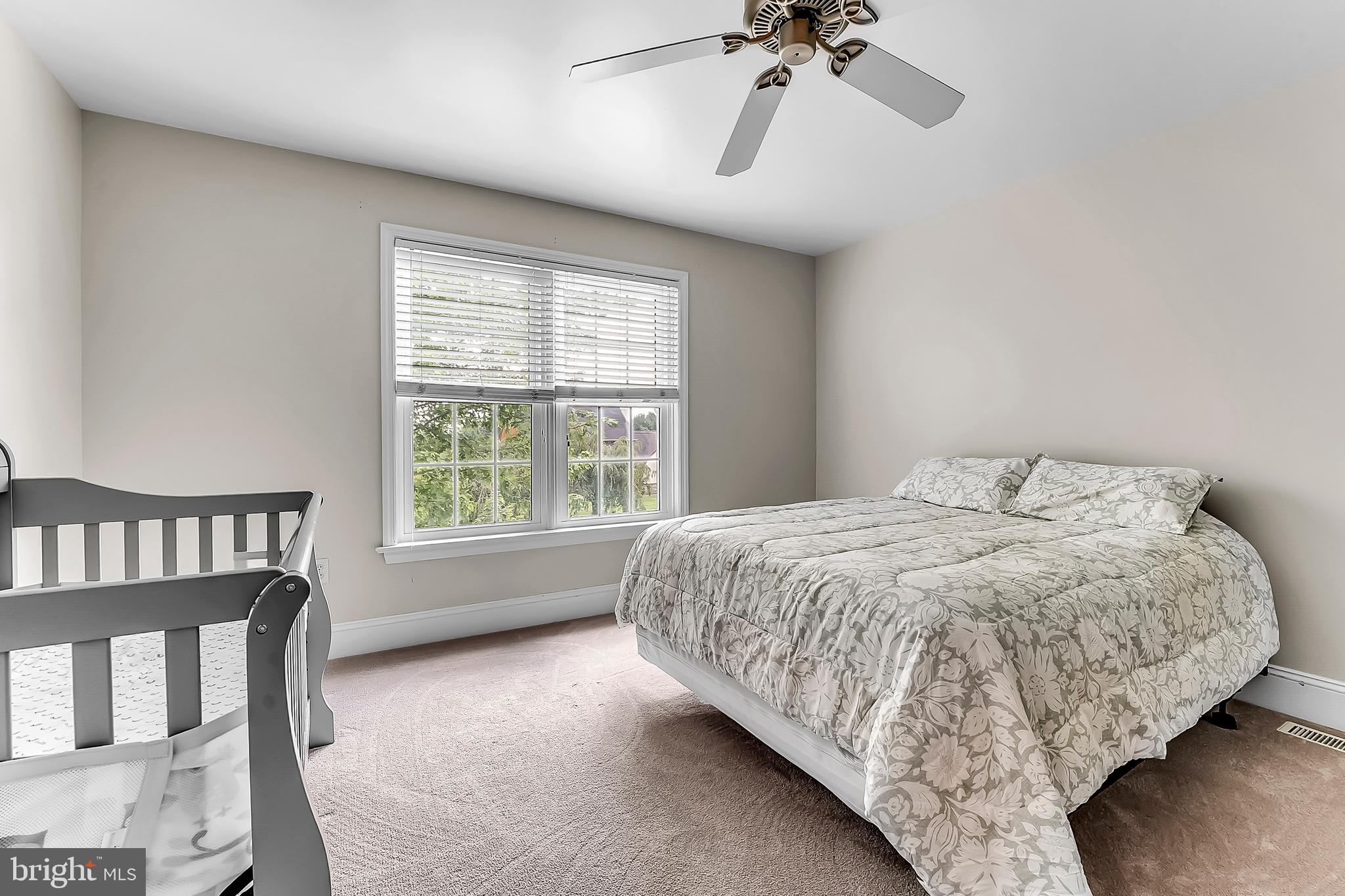 961 Buckwalter Road Lititz, PA 17543 - Photo 28 of 38 a bedroom with a bed next to a window with a chandelier