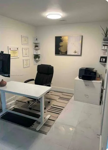 a view of water heater room with wooden floor