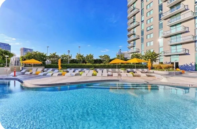 a swimming pool with outdoor seating and yard