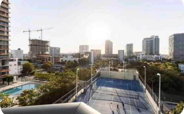 a room with a chair and a potted plant