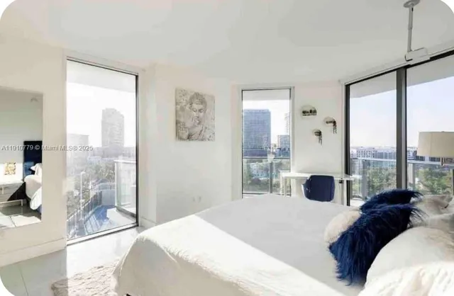 a bedroom with a large bed and a large window