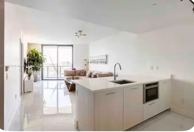a view of a kitchen with electric appliances