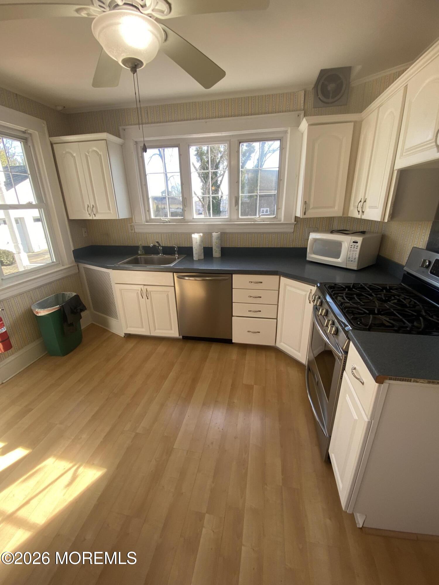 16 Hillcrest Road Elberon, NJ 07740 - Photo 8 of 22 a kitchen with stainless steel appliances granite countertop a stove a sink and a microwave