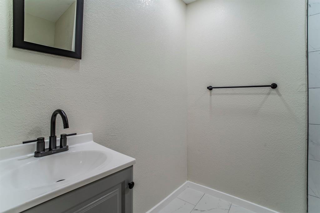5914 Victor Street Dallas, TX 75214 - Photo 20 of 32 a bathroom with a sink and mirror
