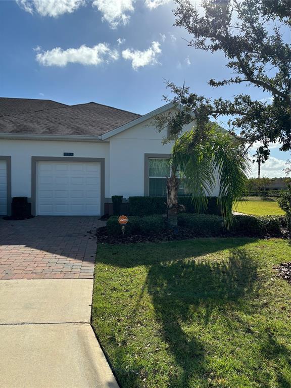 3521 Belland Circle, Unit A Clermont, FL 34711 - Photo 1 of 1 a house with garden in front of it