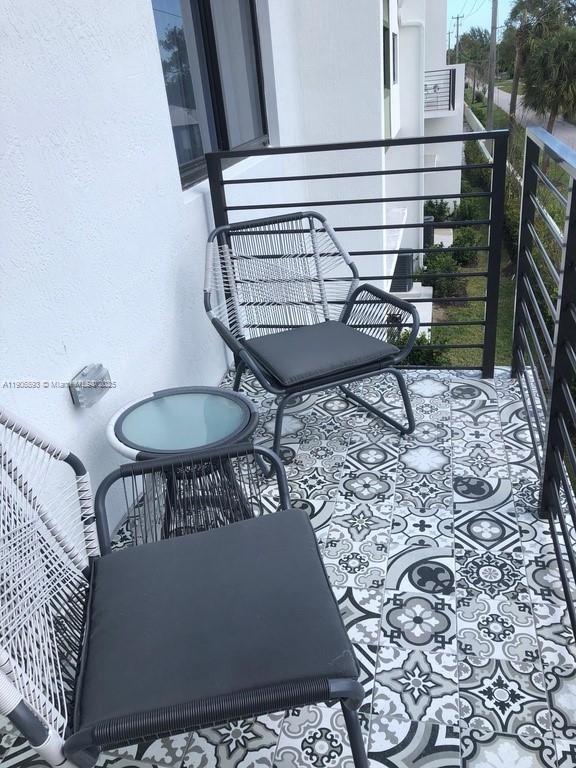 4500 Northwest 8th Place Plantation, FL 33317 - Photo 23 of 31 a view of a balcony with chairs and wooden floor