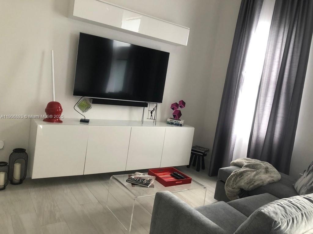 4500 Northwest 8th Place Plantation, FL 33317 - Photo 9 of 31 a living room with furniture and a flat screen tv