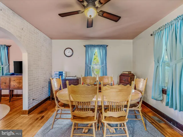 a view of a dining room with furniture and a chandelier