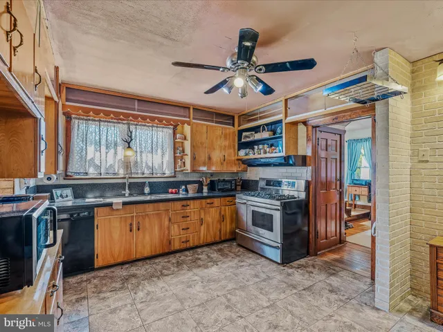 a kitchen with stainless steel appliances granite countertop a stove and a sink