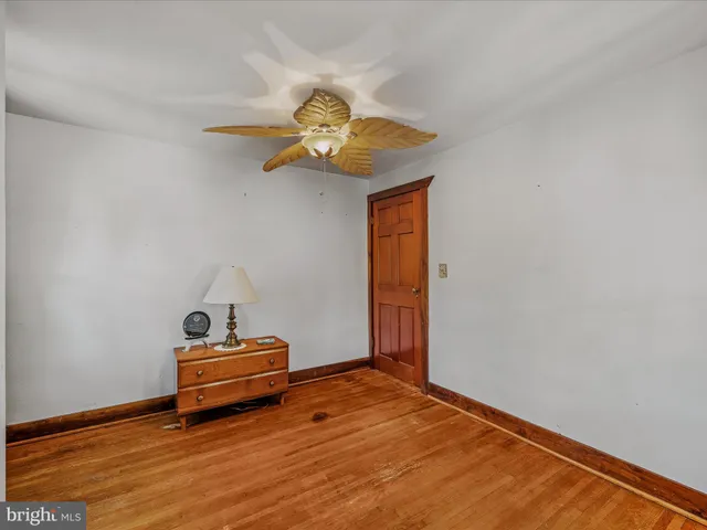 a view of room with wooden floor and fan
