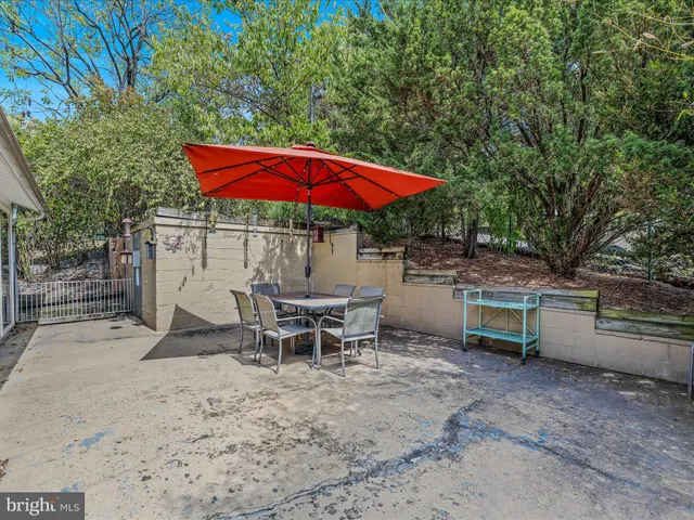 a view of a backyard with a patio and outdoor seating