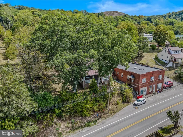 an aerial view of a houses with street view