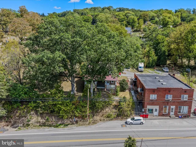 an aerial view of a houses with yard