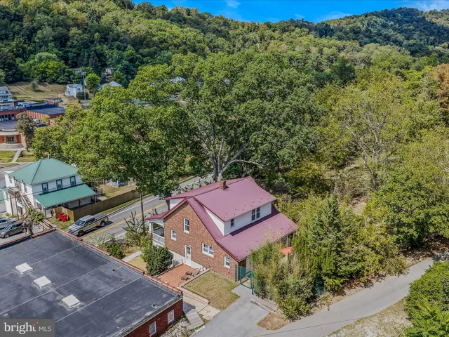 an aerial view of a house with a yard