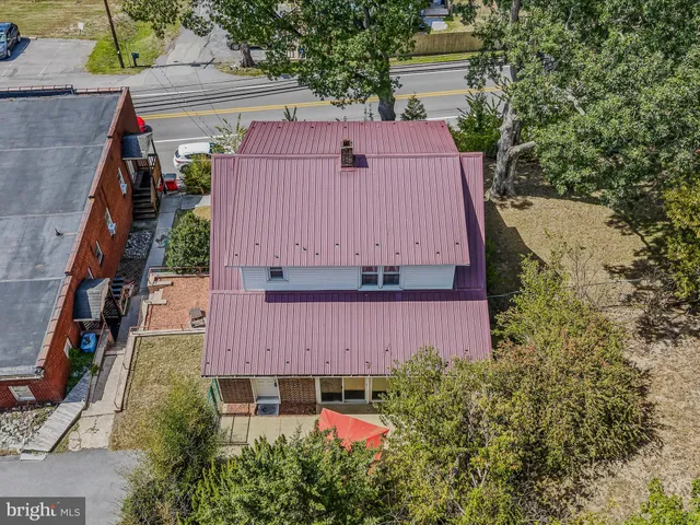 a aerial view of a house with garden space and street view