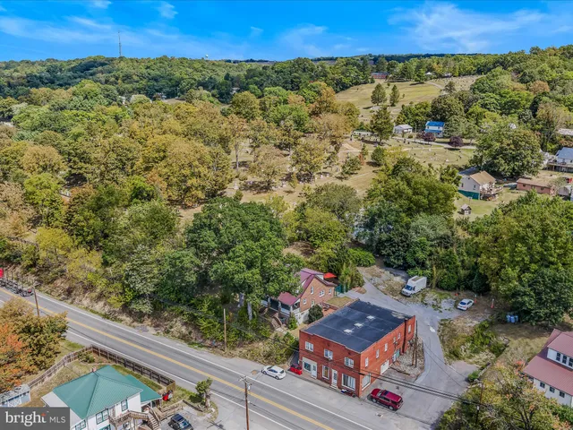 an aerial view of a residential houses covered with trees