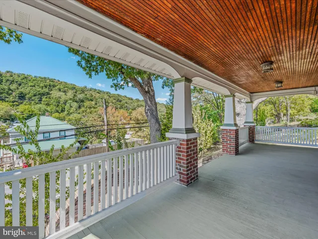 a view of a porch with furniture and a yard
