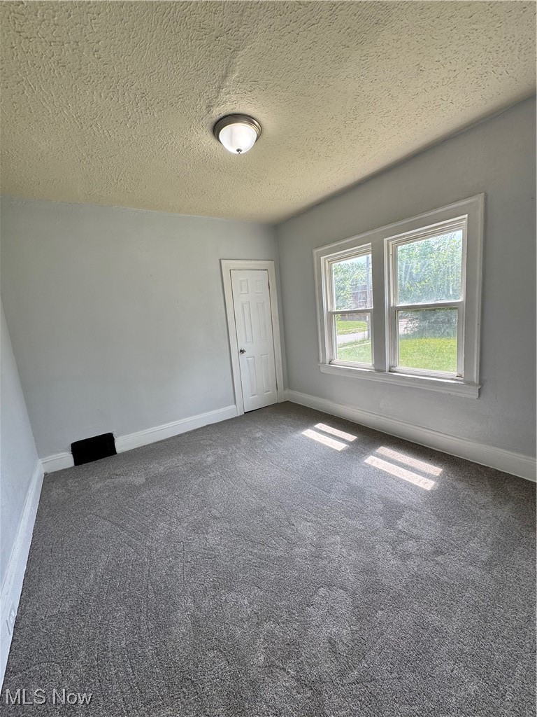 3624 East 118th Street Cleveland, OH 44105 - Photo 14 of 49 Empty room with carpet floors and a textured ceiling