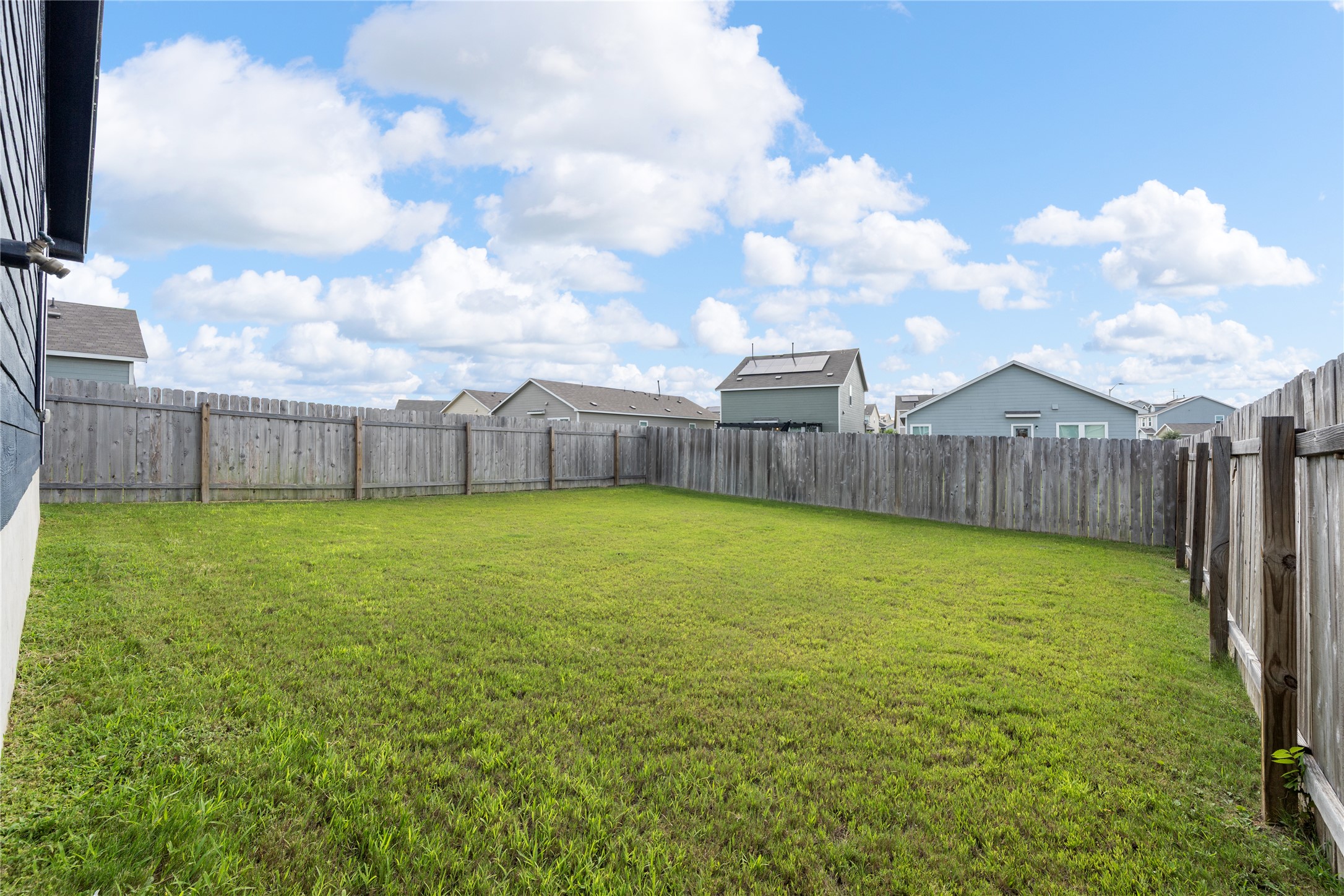 14404 Berning Road Manor, TX 78653 - Photo 34 of 38 A spacious backyard awaits, fully fenced for privacy and outdoor enjoyment.