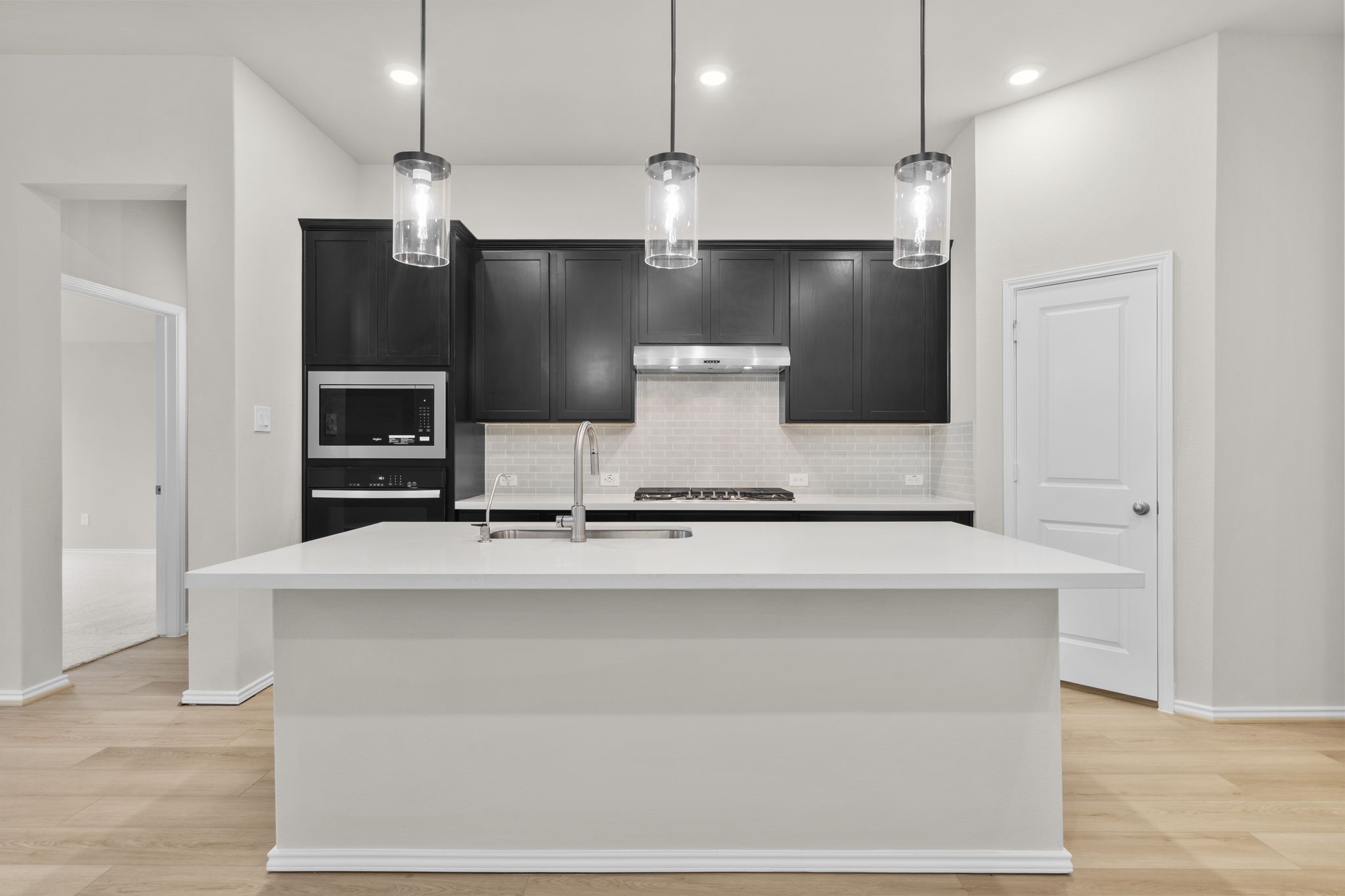 9519 Sierra Crest Lane Porter, TX 77365 - Photo 3 of 35 a large kitchen with stainless steel appliances a large counter top a stove and a refrigerator