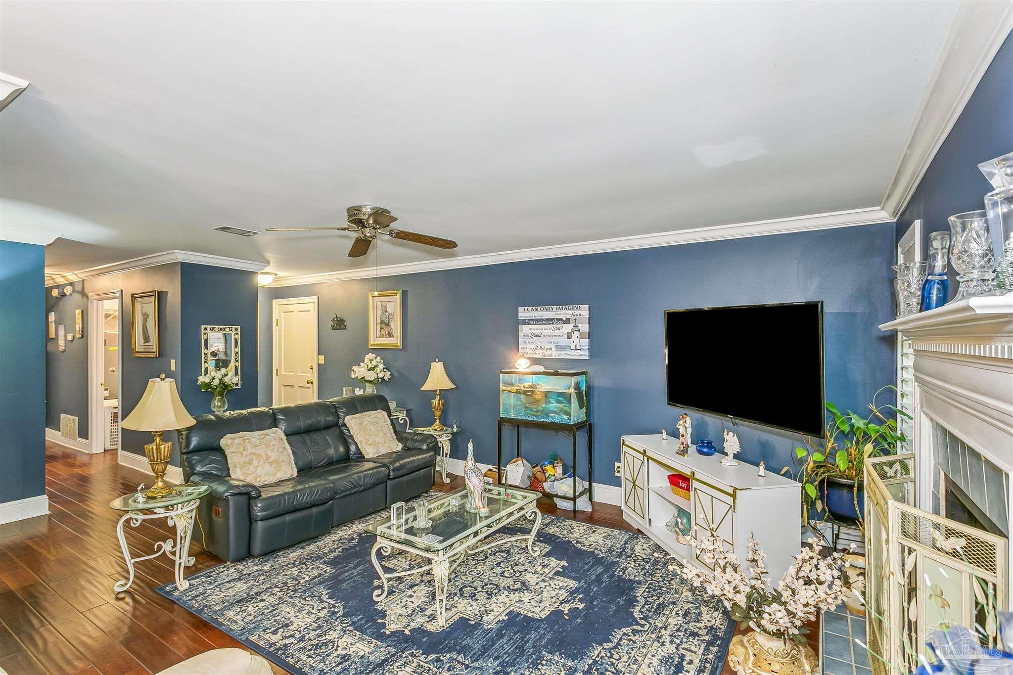 4831 East Olive Road, Unit 2D Pensacola, FL 32514 - Photo 12 of 29 a living room with furniture and a flat screen tv