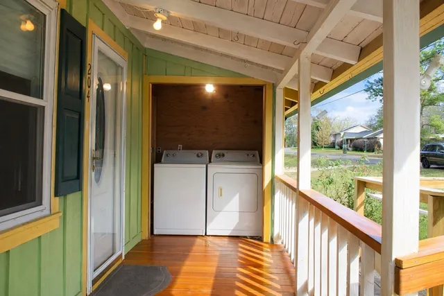 a view of hallway with a large window and wooden floor
