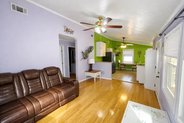 a living room with furniture and a chandelier