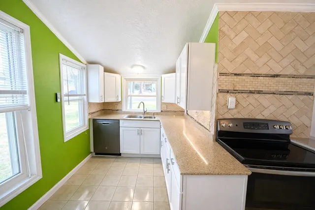 a kitchen with a refrigerator and a sink