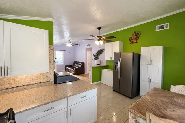 a kitchen with a refrigerator and a sink