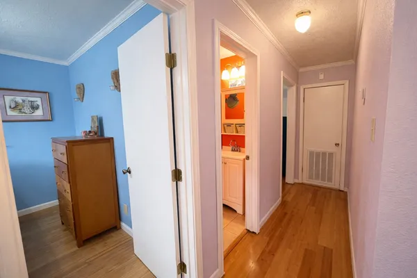 a view of a hallway with wooden floor