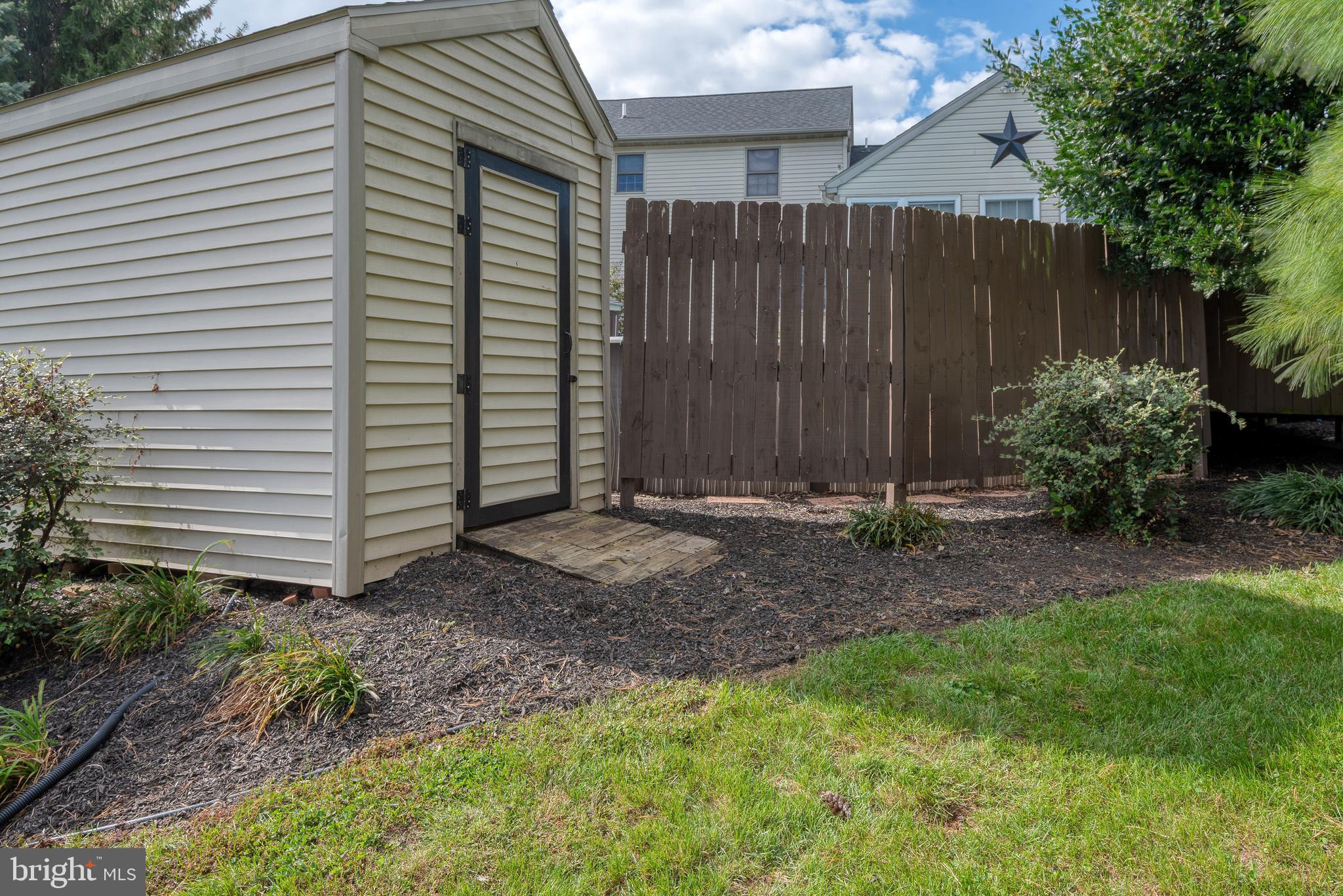 5 Village Drive Lititz, PA 17543 - Photo 54 of 62 a view of a backyard with plants and wooden fence