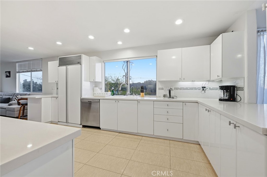 12815 Via Nestore Del Mar, CA 92014 - Photo 12 of 42 a kitchen with white cabinets a sink and white appliances