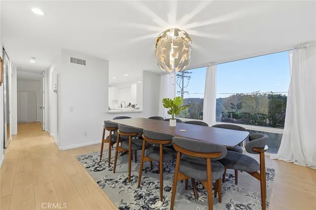 a view of a dining room with furniture window and wooden floor